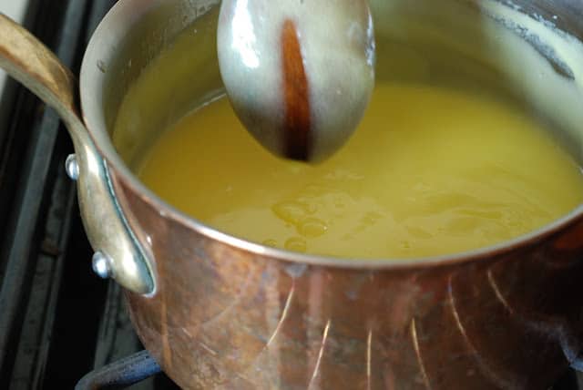 Wooden spoon showing thicken lemon curd with trail on spoon