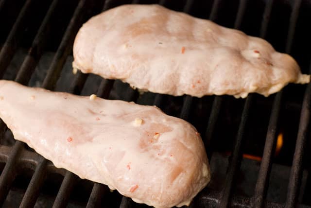 Marinated chicken breasts on grill