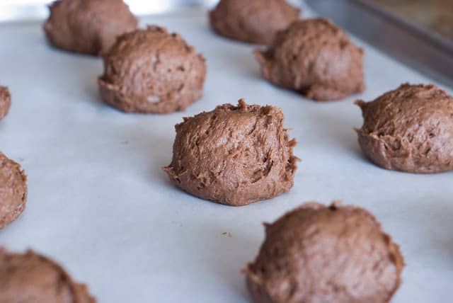 Mounds of chocolate cookie dough on baking sheet