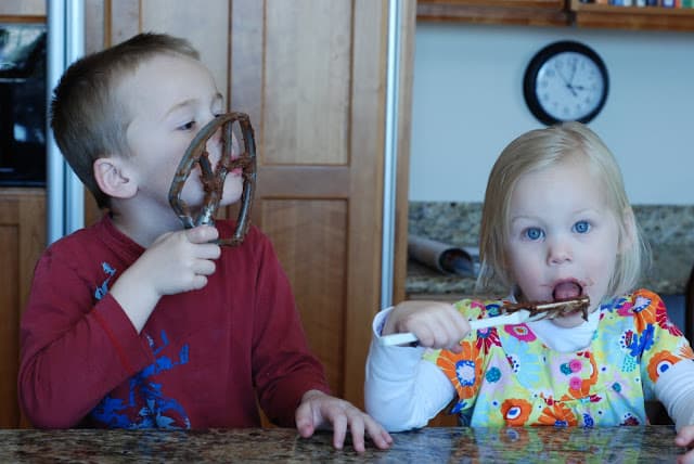 boy and girl licking chocolate cookie batter from beaters