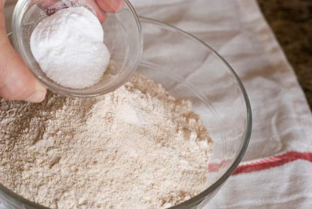 Wheat flour in bowl adding baking soda