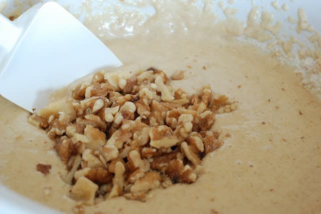 chopped walnuts on top of banana bread batter