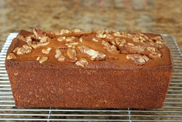 Banana nut bread removed from pan sitting on a cooling rack.