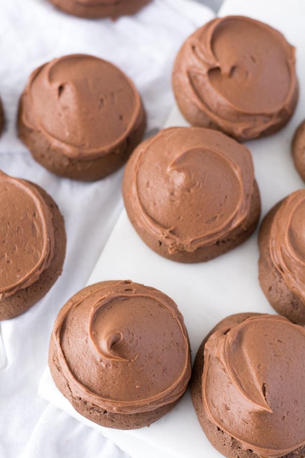 Several chocolate drop cookies on white background