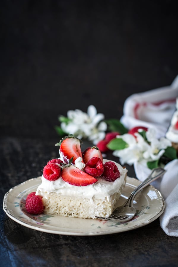 slice of cake with berries on plate