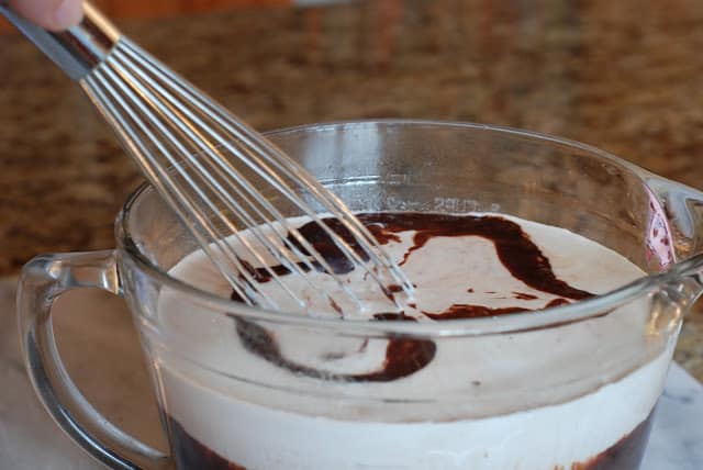 Whisking in cream into chocolate mixture