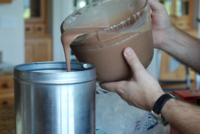 Pouring ice cream custard into drum of ice cream maker