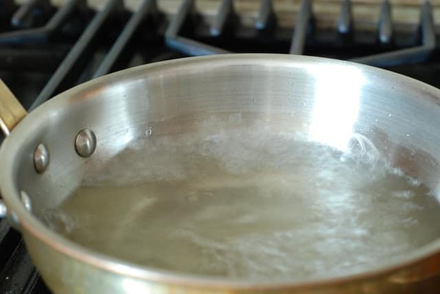 sugar and water boiling in a saucepan