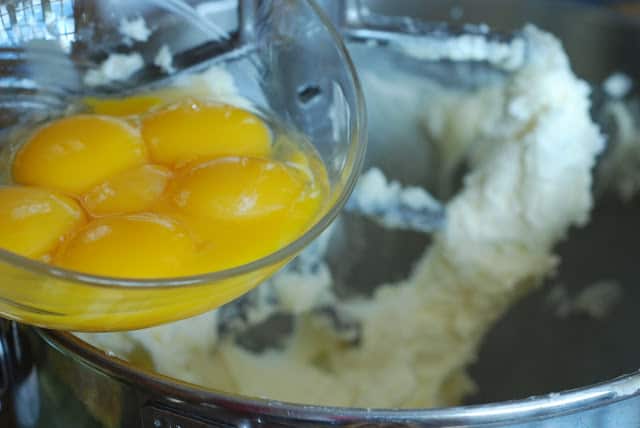 Egg yolks being poured into bowl