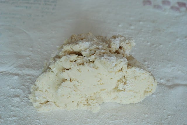 Sour cream sugar cookie dough on a floured surface.