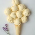 several scoops of Honey Lavender Ice Cream on a marble board with one cone