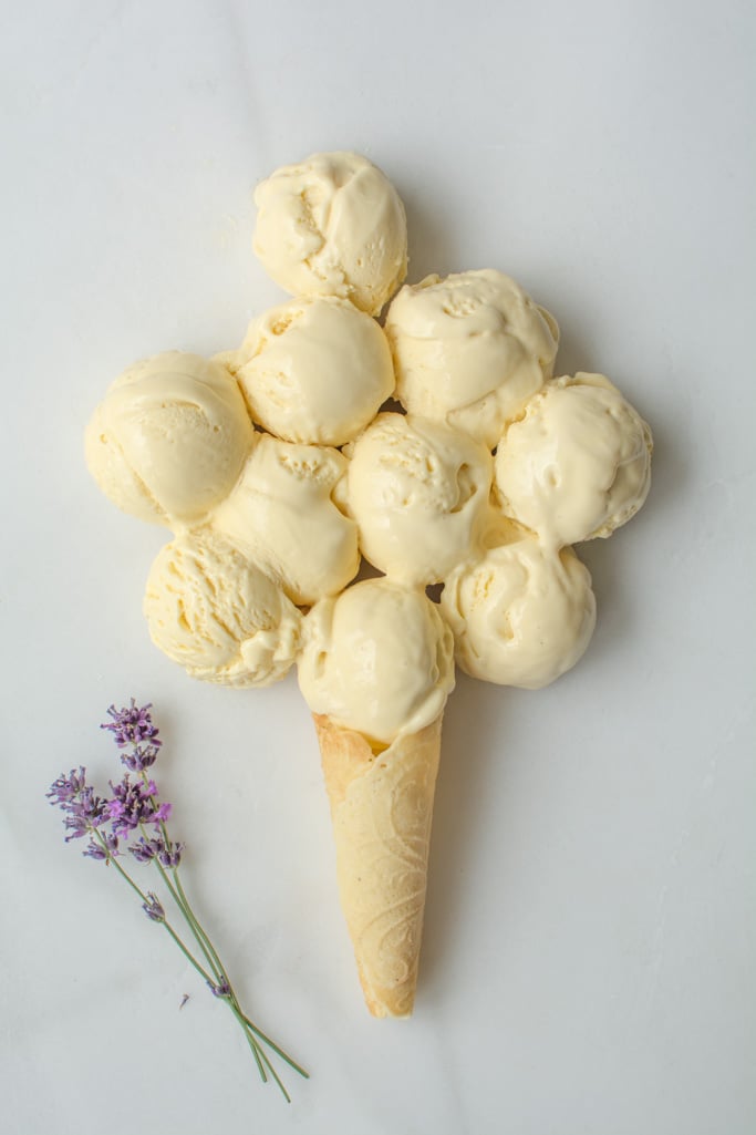 several scoops of Honey Lavender Ice Cream on a marble board with one cone