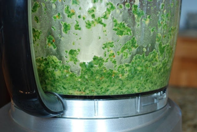 Food processor mixing basil pesto