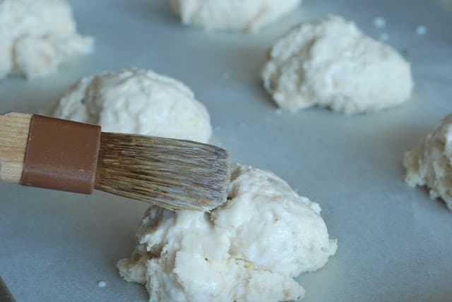 brushing tops of dropped shortcake dough with buttermilk