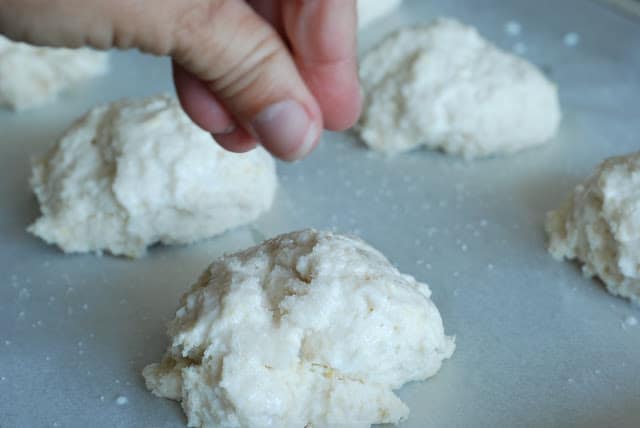fingers shown sprinkling shortbread with sugar