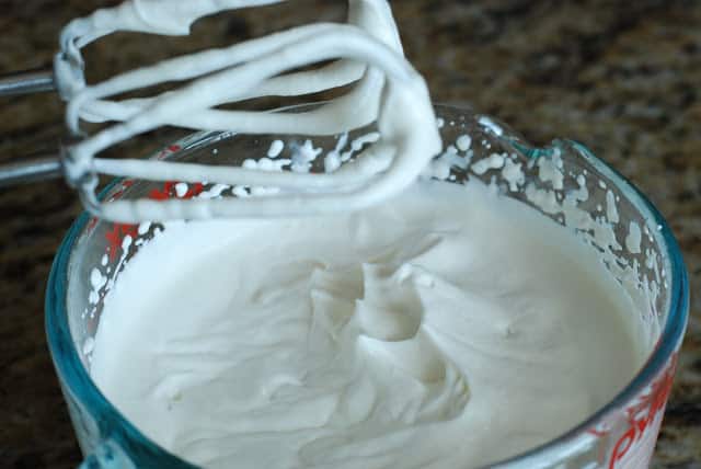 whipped cream in bowl with mixer blades