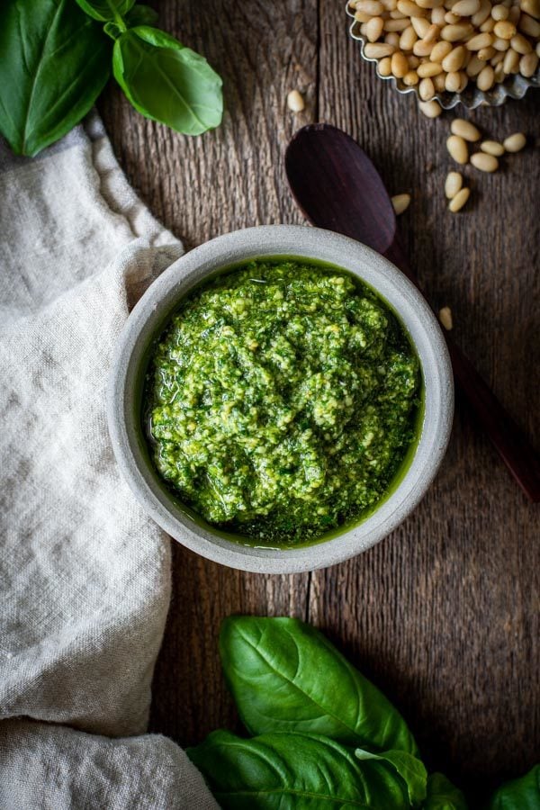 Perfect Basil Pesto in a bowl with wood spoon and fresh basil