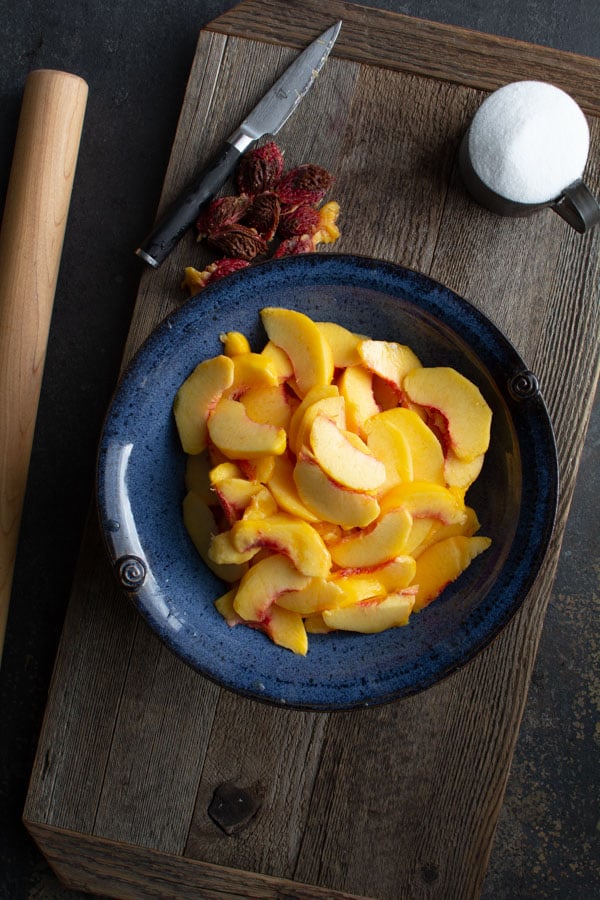 Large blue bowl with sliced peaches