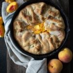 Baked southern peach cobbler in cast iron skillet