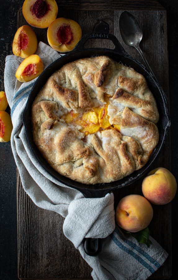 Baked southern peach cobbler in cast iron skillet