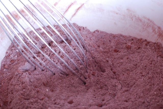 Bowl with mixture of flour, sugar, cocoa with whisk