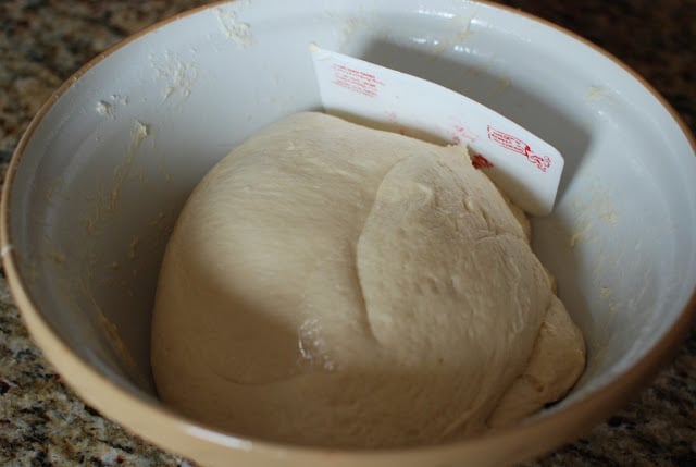 large bowl of dough with dough scraper