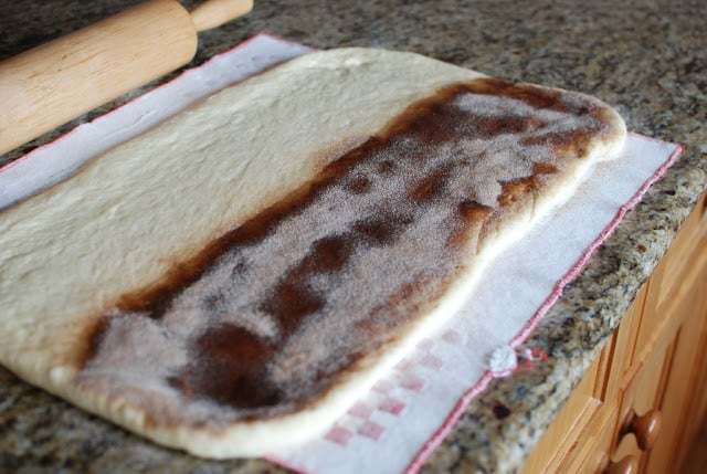 Sugar cinnamon mixture sprinkled on half of rolled dough