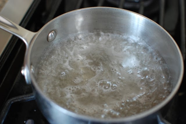 sugar water mixture boiling in saucepan