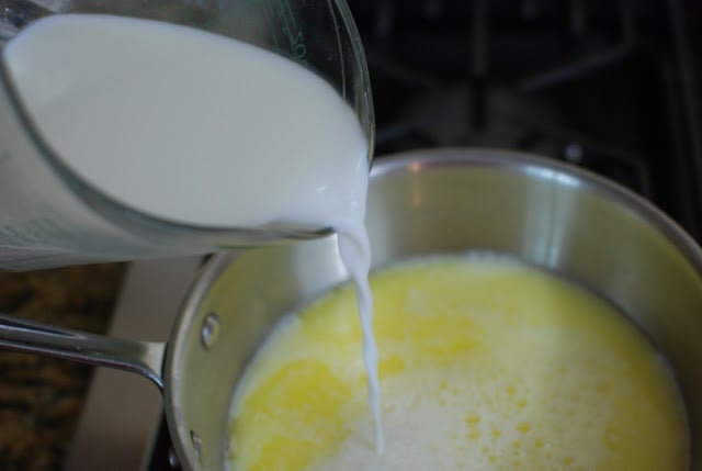 milk pouring into melted butter