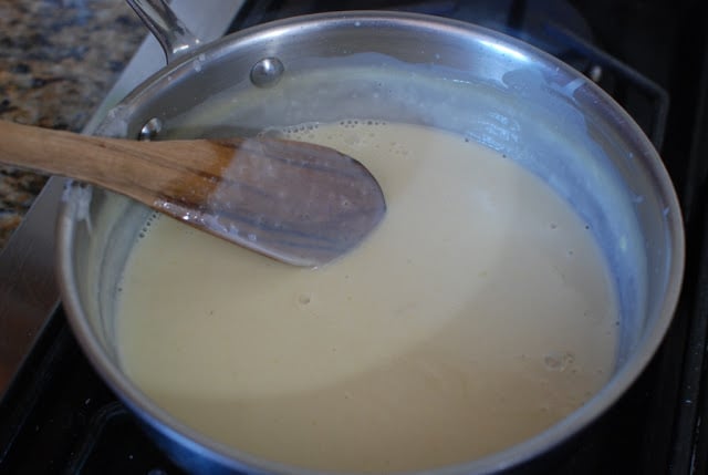 wooden spoon stirring ice cream mixture