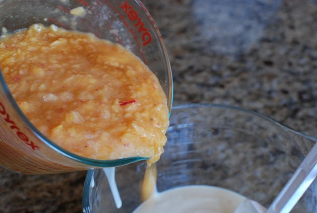 pureed peaches pouring into custard