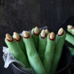green Witch Finger Cookies standing in a black bowl