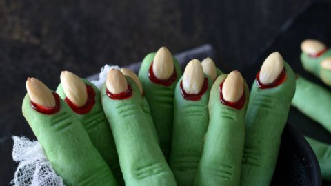 green Witch Finger Cookies standing in a black bowl