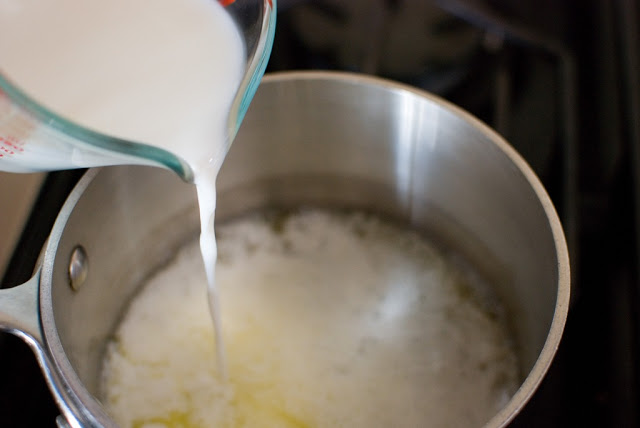 milk pouring into melted butter