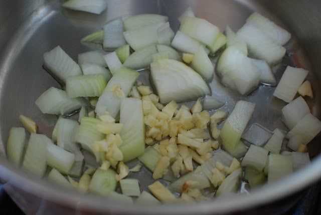 Onions and garlic sauteeing in a pot