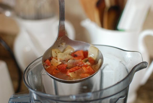 Ladle of soup over blender container