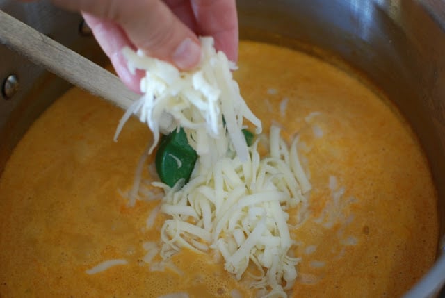 Grated jack cheese added to tortilla soup