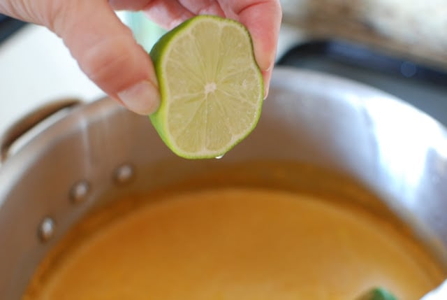 hand squeezing lime over tortilla soup
