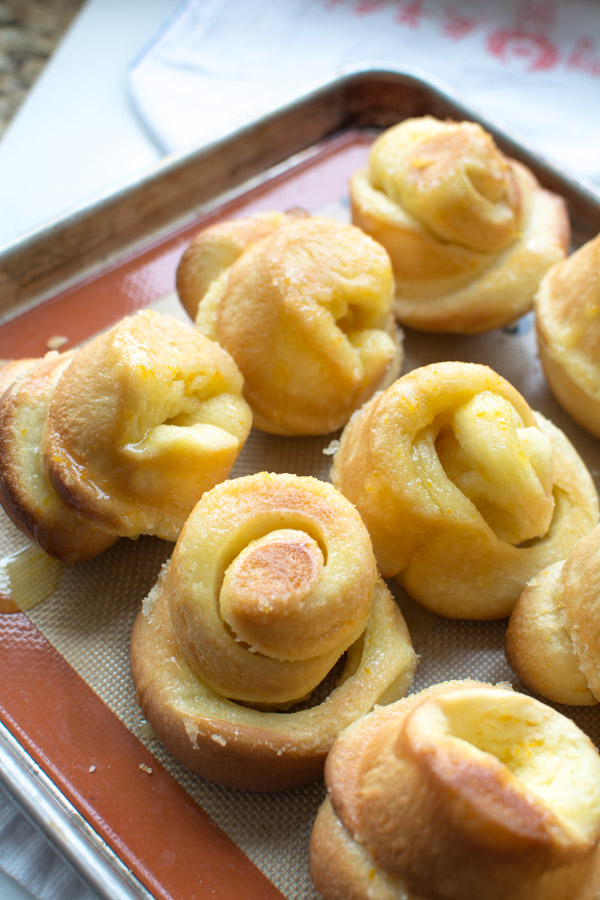 baked orange rolls tipped out of tin