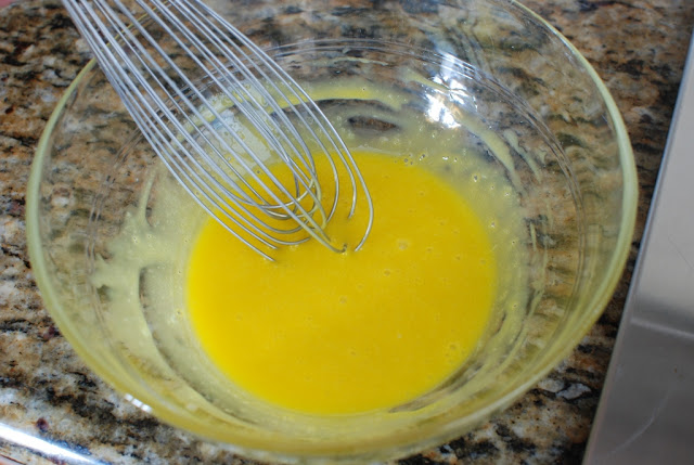 Whisking egg yolks in clear bowl
