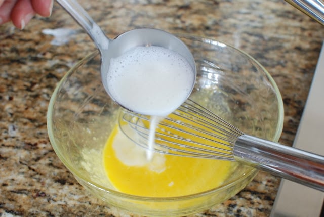 Ladle hot cream mixture into egg yolks