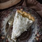 Over head shot of one slice coconut cream pie on a decorative plate