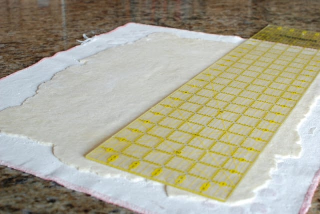 Large rectangle of dough rolled thin on a pastry cloth.