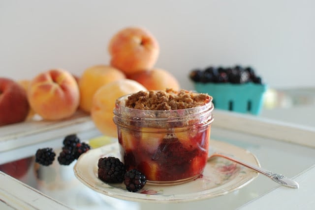 mason jar filled with blackberry peach crisp