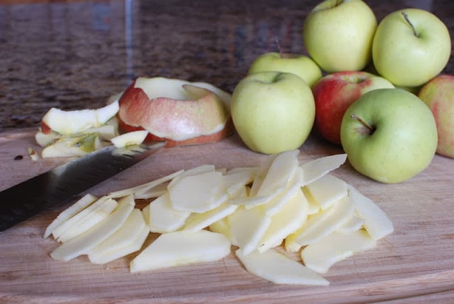 Apples on a cutting board with thin slice apple