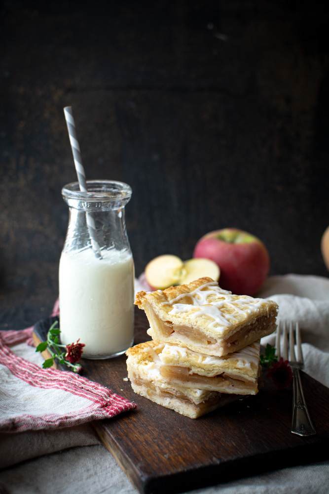 slices of slab apple pie stacked on cutting board