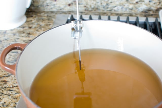 Large dutch oven pot with 2-inches of oil and thermometer attached.