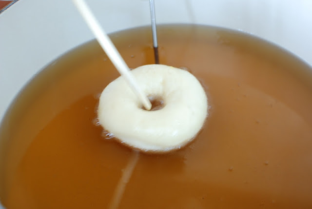 Spudnut added to hot oil with chopstick to turn over