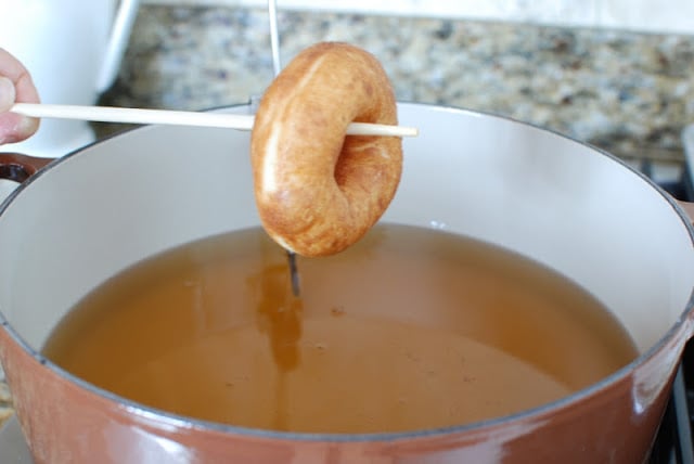Lifting spudnut from hot oil with chopstick