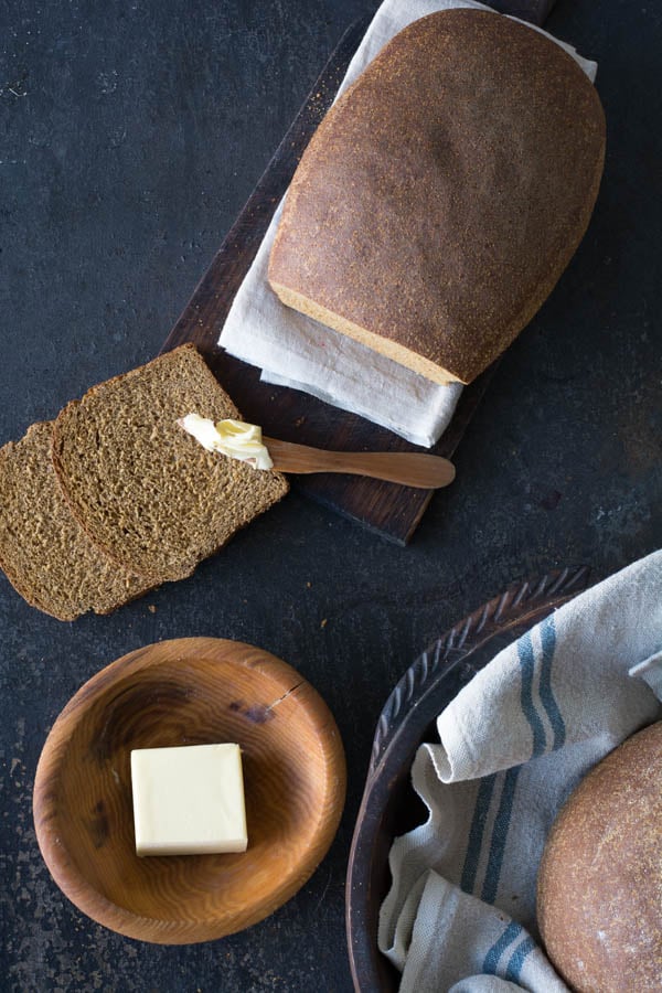 Bread sliced with bowl of butter